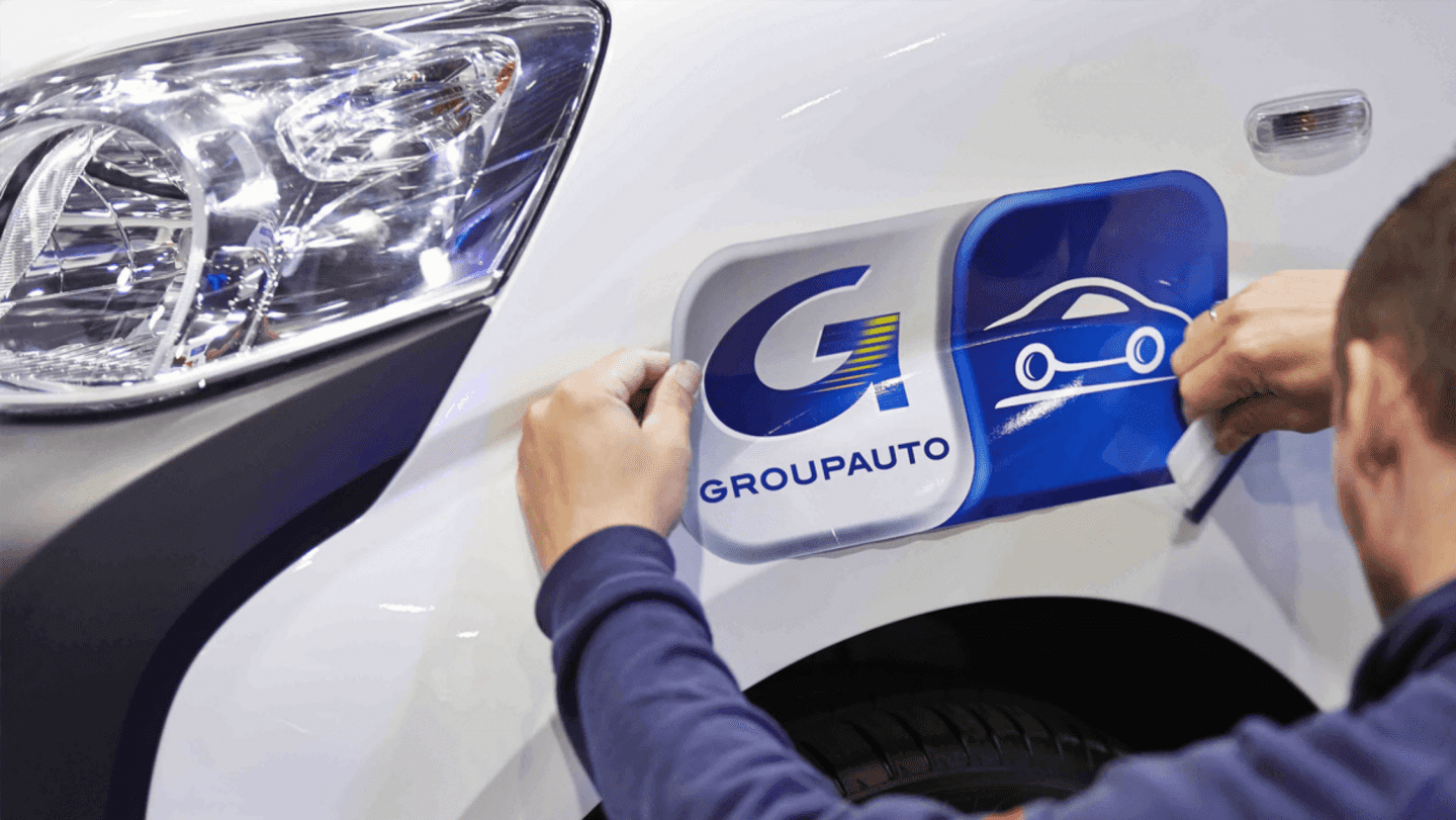 Groupauto sticker being place on a car